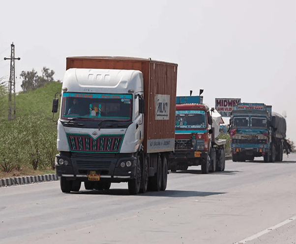 Trucks on a highway, indicating freight movement